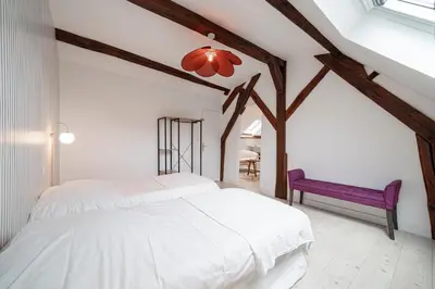Un ou plusieurs lits dans un hébergement de l'établissement Les Mansardes : Duplex champenois typique et cosy