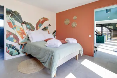 Un ou plusieurs lits dans un hébergement de l'établissement Un nid dans la Grange - Maison avec jacuzzi et sauna