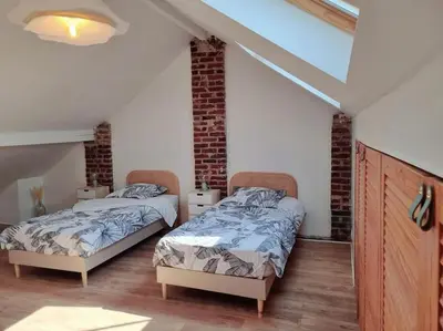 Un ou plusieurs lits dans un hébergement de l'établissement La Citadine, maison avec jardin…