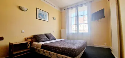 Un ou plusieurs lits dans un hébergement de l'établissement Hôtel de la cloche