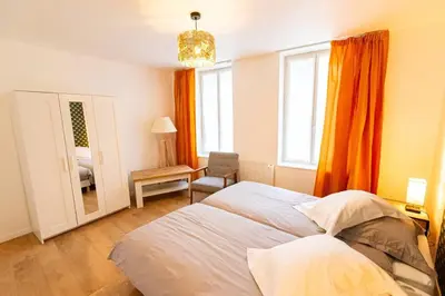 Un ou plusieurs lits dans un hébergement de l'établissement Gîte d'Artagnan 3 chambres