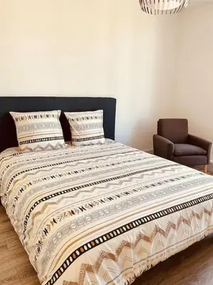 Un ou plusieurs lits dans un hébergement de l'établissement Studio de la Belle Vue