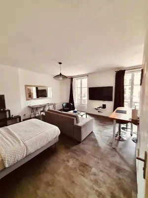 Un ou plusieurs lits dans un hébergement de l'établissement Studio de l'hôtel de ville