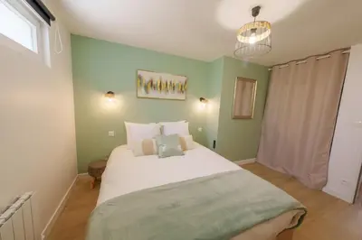 Un ou plusieurs lits dans un hébergement de l'établissement L'Escale Tropicale, appartement indépendant avec terrasse privative