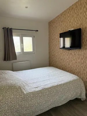Un ou plusieurs lits dans un hébergement de l'établissement Studio meublé marne la vallée / Disneyland