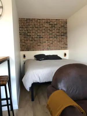 Un ou plusieurs lits dans un hébergement de l'établissement Studio cosy vue cathédrale
