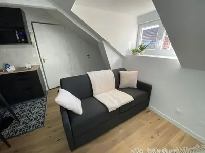 Coin salon dans l'établissement Appartement - Le cocon Rémois