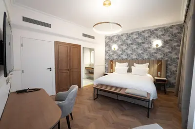 Un ou plusieurs lits dans un hébergement de l'établissement Hôtel Margaux