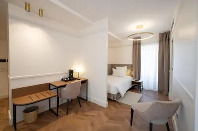 Un ou plusieurs lits dans un hébergement de l'établissement Hôtel Margaux