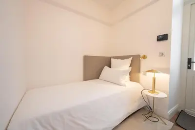 Un ou plusieurs lits dans un hébergement de l'établissement Hôtel Margaux