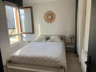 Un ou plusieurs lits dans un hébergement de l'établissement Appartement joli et spacieux