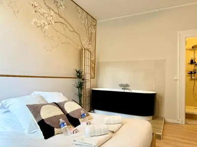 Un ou plusieurs lits dans un hébergement de l'établissement Relax Inn Champagne - Reims Balnéo