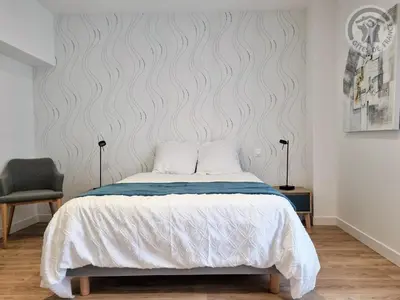 Un ou plusieurs lits dans un hébergement de l'établissement Gîte chaleureux avec WIFI et grand jardin, près de Disneyland - FR-1-532-22
