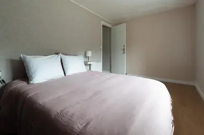 Un ou plusieurs lits dans un hébergement de l'établissement Charmante maison au calme avec terrasse & parking