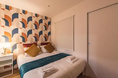 Un ou plusieurs lits dans un hébergement de l'établissement MM Suites Saint-Remi