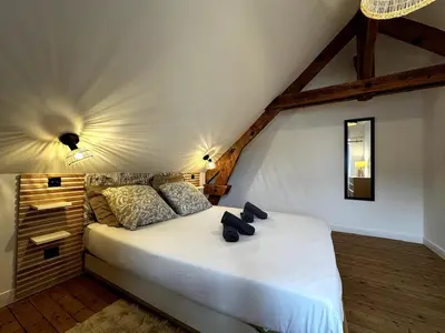 Un ou plusieurs lits dans un hébergement de l'établissement Grande maison de charme avec jardin
