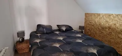 Un ou plusieurs lits dans un hébergement de l'établissement appartement dans une écurie