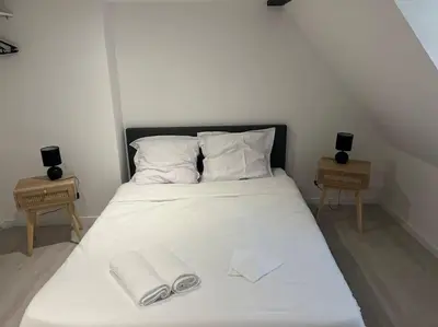 Un ou plusieurs lits dans un hébergement de l'établissement Appartements Avesnes sur Helpe Cosy T2