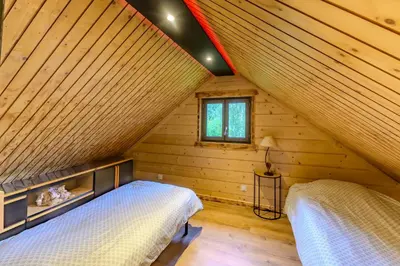 Un ou plusieurs lits dans un hébergement de l'établissement Rêves au Chalet - Maisonnette