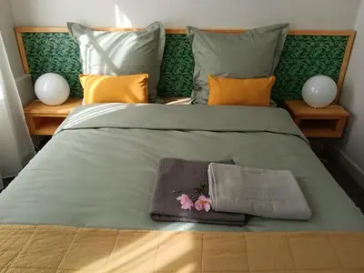 Un ou plusieurs lits dans un hébergement de l'établissement Appartement au cœur de la Petite Cité de Caractère
