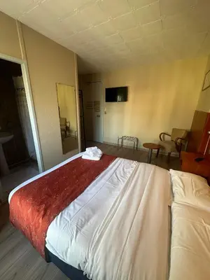 Un ou plusieurs lits dans un hébergement de l'établissement Hôtel Victoria