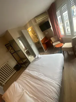 Un ou plusieurs lits dans un hébergement de l'établissement Hôtel Victoria