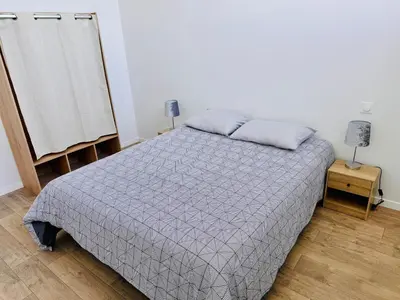 Un ou plusieurs lits dans un hébergement de l'établissement Appartement Magnum