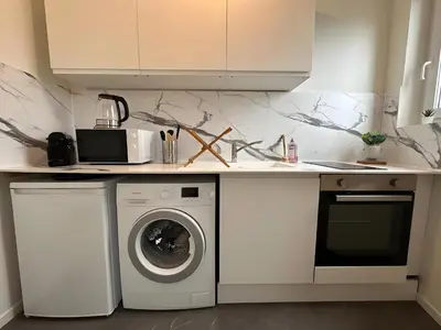 Cuisine ou kitchenette dans l'établissement L'Appartement du Forum - Reims centre Cathédrale