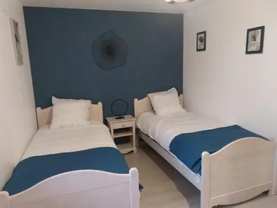 Un ou plusieurs lits dans un hébergement de l'établissement Le murmure du ruisseau - Pièce de vie 60 m2 - Terrasse 30 M2 - 2 WC