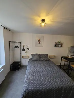 Un ou plusieurs lits dans un hébergement de l'établissement Cosy Studio Confort