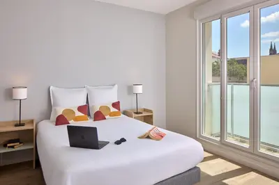 Un ou plusieurs lits dans un hébergement de l'établissement Quality Aparthotel Reims - Saint-Thomas