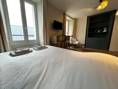 Un ou plusieurs lits dans un hébergement de l'établissement E2 Reton Studio Cosy proche du centre-ville