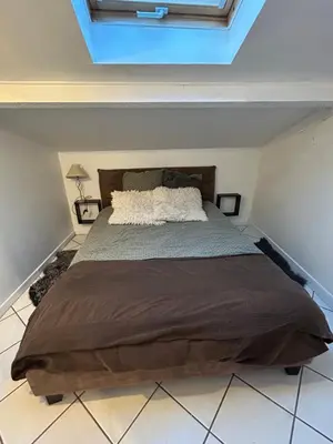 Un ou plusieurs lits dans un hébergement de l'établissement Petite maison dans village animé