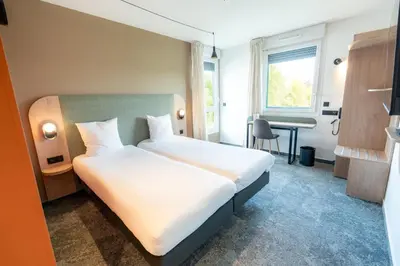 Un ou plusieurs lits dans un hébergement de l'établissement Hôtel AKENA Chalons-en-Champagne