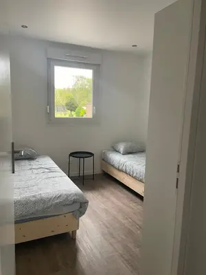 Un ou plusieurs lits dans un hébergement de l'établissement Appartement climatisé neuf