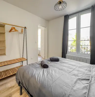 Un ou plusieurs lits dans un hébergement de l'établissement Le City Chic