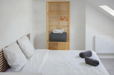 Un ou plusieurs lits dans un hébergement de l'établissement Le Duplex de l'Hôtel-de-Ville