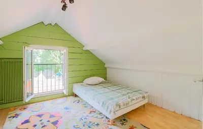 Un ou plusieurs lits dans un hébergement de l'établissement Jolie Maison Proche Rivière