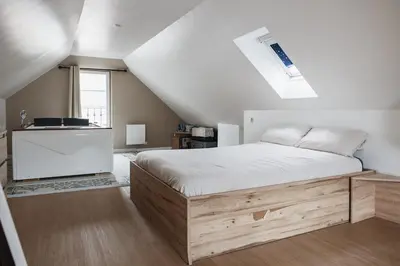 Un ou plusieurs lits dans un hébergement de l'établissement Evasion Prestige - Duplex Balnéo, Sauna & Billard