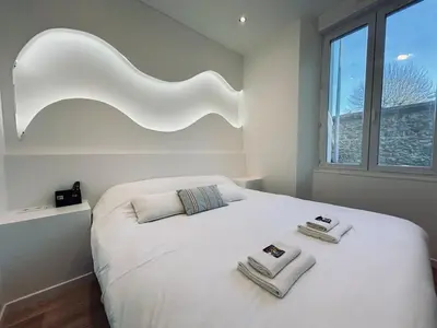 Un ou plusieurs lits dans un hébergement de l'établissement E Petit Prince T3 avec SPA & Lit King size