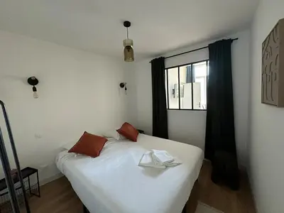 Un ou plusieurs lits dans un hébergement de l'établissement Suite Nova 4 personnes - Vue Hôtel de Ville - à quelques minutes du centre-ville de Charleville-Mézières