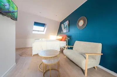 Coin salon dans l'établissement Aceta Home Saint-Quentin - Appartement Jardin Sauge