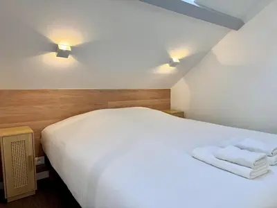 Un ou plusieurs lits dans un hébergement de l'établissement Wellness Suite Ponsardin 3 - Reims Centre