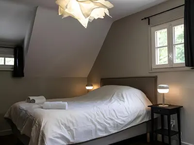 Un ou plusieurs lits dans un hébergement de l'établissement Charmante demeure au coeur des Bois