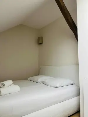 Un ou plusieurs lits dans un hébergement de l'établissement Suite Muraille by Collection Aura - 4p - Hypercentre Charleville-Mézières à deux pas de la Place Ducale