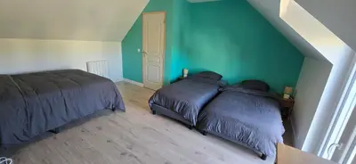 Un ou plusieurs lits dans un hébergement de l'établissement Cozyhouse 2 chambre, 6 personnes avec jardin