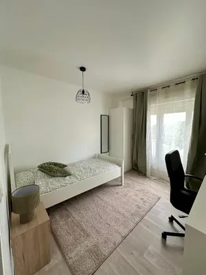 Un ou plusieurs lits dans un hébergement de l'établissement Appartement REIMS 3 chambres