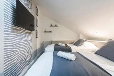 Un ou plusieurs lits dans un hébergement de l'établissement MM Suites City House Cathedrale