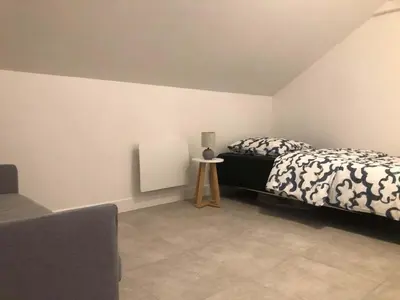 Un ou plusieurs lits dans un hébergement de l'établissement Deux appartements proche Disneyland