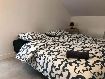Un ou plusieurs lits dans un hébergement de l'établissement Deux appartements proche Disneyland